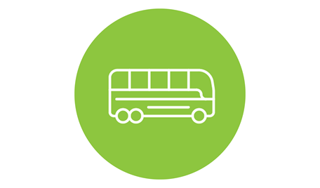 En grön platta med en vit buss illustrerad