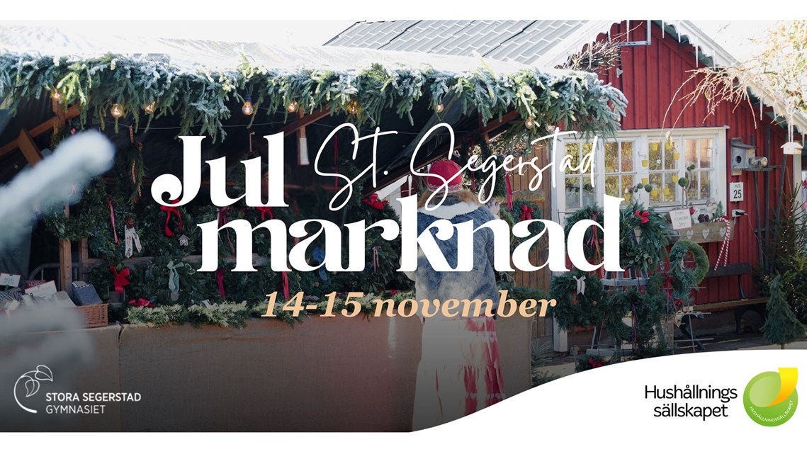 Ett hantverksstånd med dörrkransar med granris på taket. På bilden syns texten Julmarknad på St. Segerstad den 14-15 november.